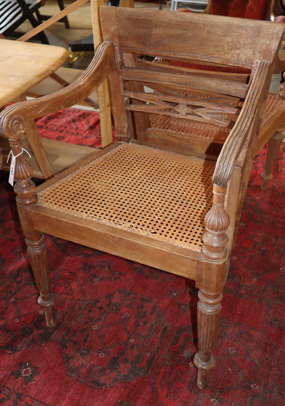 A set of six Anglo Indian teak cane seat elbow chairs